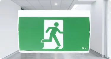 E&E surface-mount exit sign in an office corridor