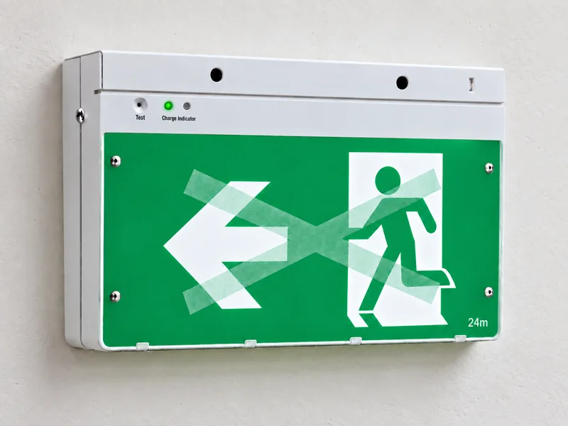 Dynamic exit sign lit as a standard green running-man legend