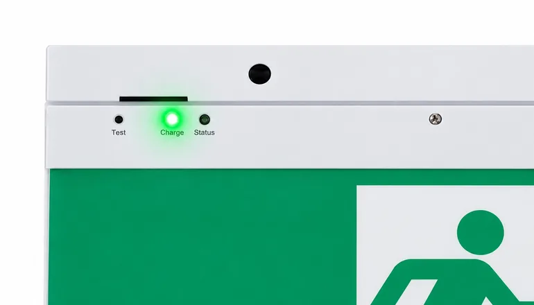 Exit sign indicator panel with the green LED lit