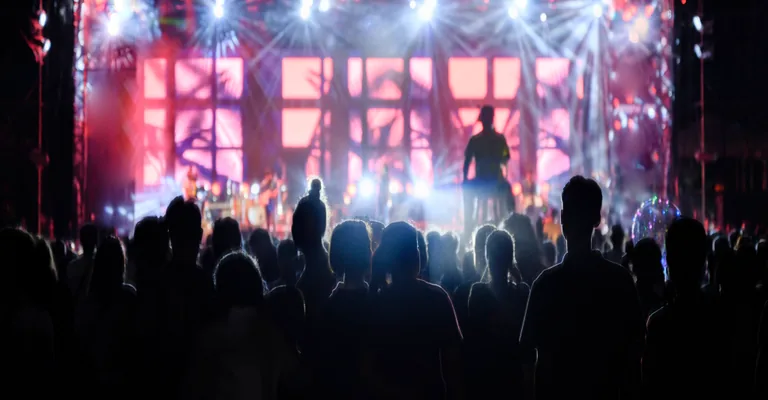 Crowd in front of a lit festival stage
